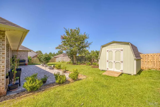 a view of a patio with table and chairs and potted plants