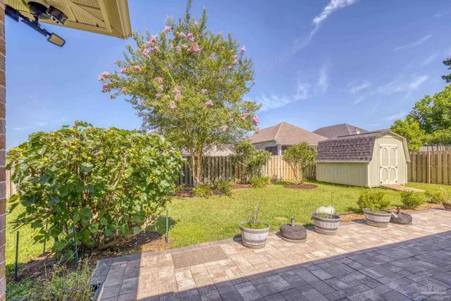 a car parked in front of a house with a yard