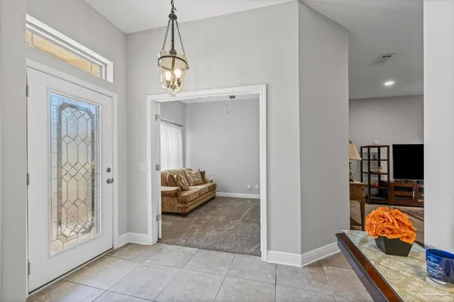 a dining room with furniture and a chandelier