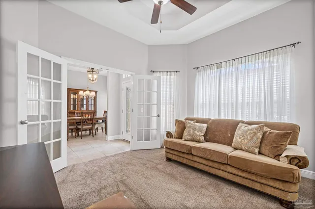 a living room with furniture and large window