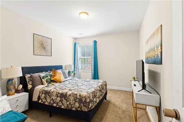 a kitchen with white cabinets and refrigerator