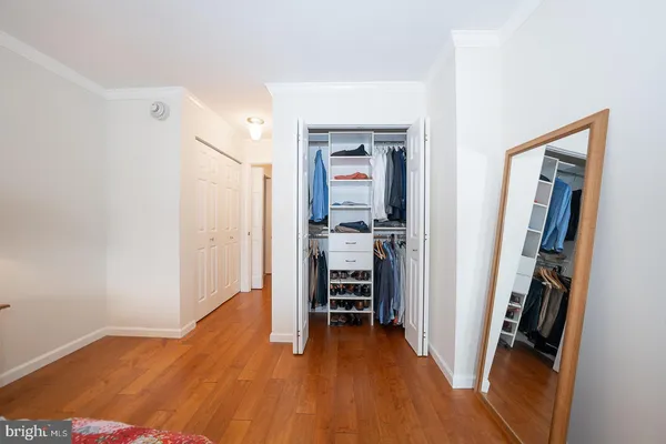 a view of a hallway with wooden floor and furniture