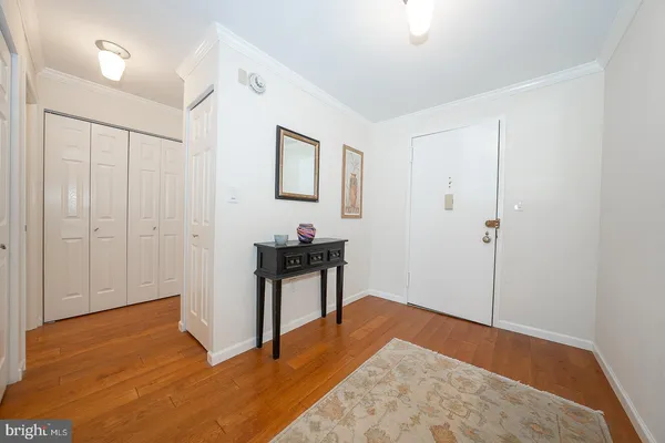 a view of a room with wooden floor and bathroom