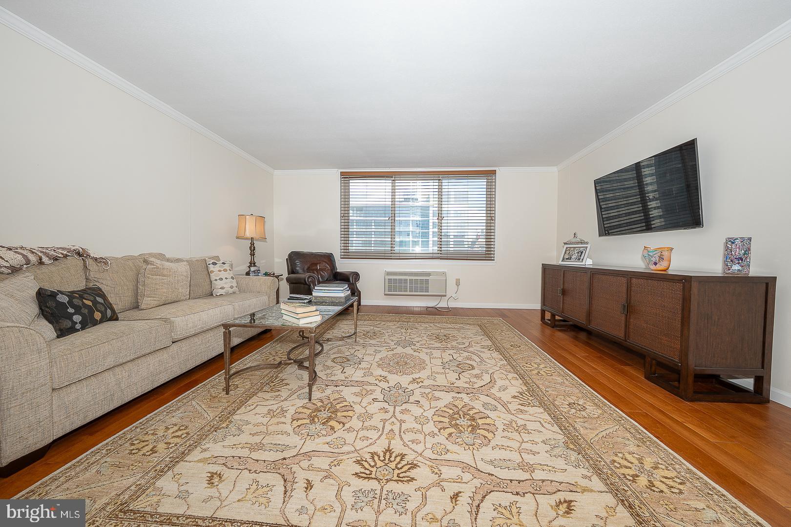 1919 Chestnut Street, Unit 2822 Philadelphia, PA 19103 - Photo 8 of 36 a living room with furniture and a flat screen tv