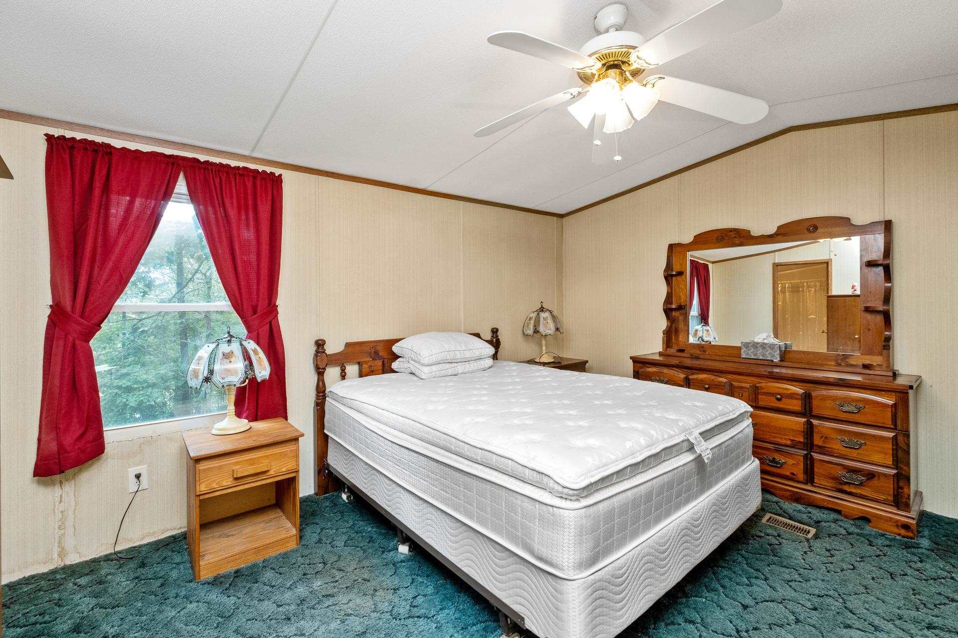 1372 Miller Farm Road Staunton, VA 24401 - Photo 21 of 27 a bedroom with a bed and a chandelier