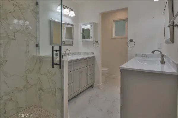 a bathroom with a granite countertop sink mirror and a bathtub