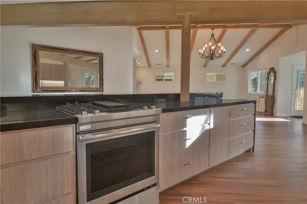 a kitchen with stainless steel appliances granite countertop a stove and a microwave