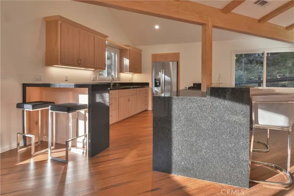 a kitchen with granite countertop a stove and a refrigerator