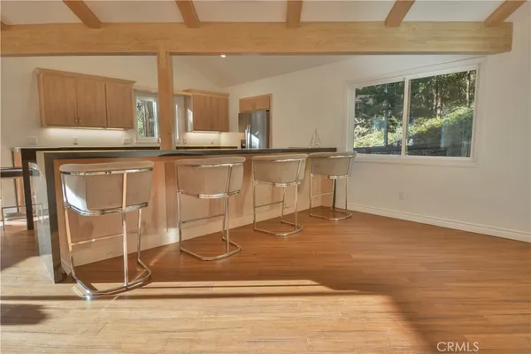 a view of a room with wooden floor and windows