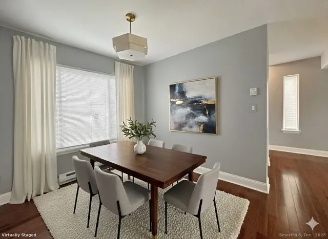 a view of a dining room with furniture and wooden floor