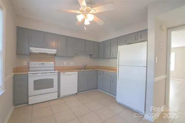 a kitchen with a refrigerator sink and cabinets