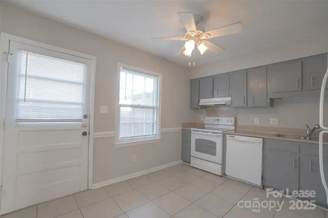 a kitchen with cabinets stainless steel appliances and window