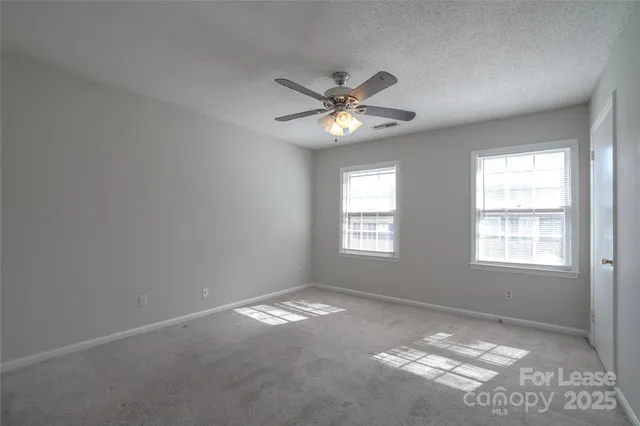 a view of a livingroom with a ceiling fan and window