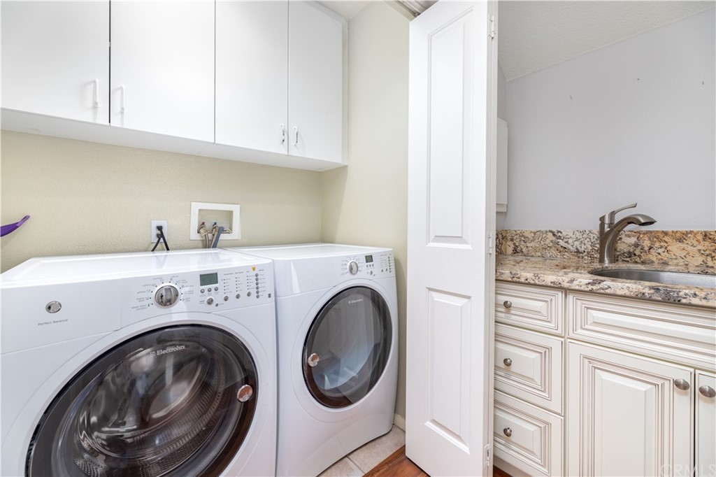 24 Silveroak Irvine, CA 92620 - Photo 12 of 23 a utility room with sink dryer and washer