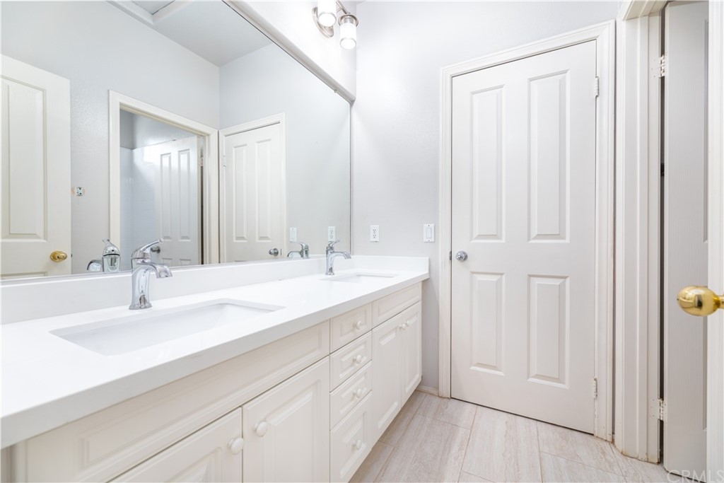 24 Silveroak Irvine, CA 92620 - Photo 16 of 23 a bathroom with a double vanity sink and a mirror