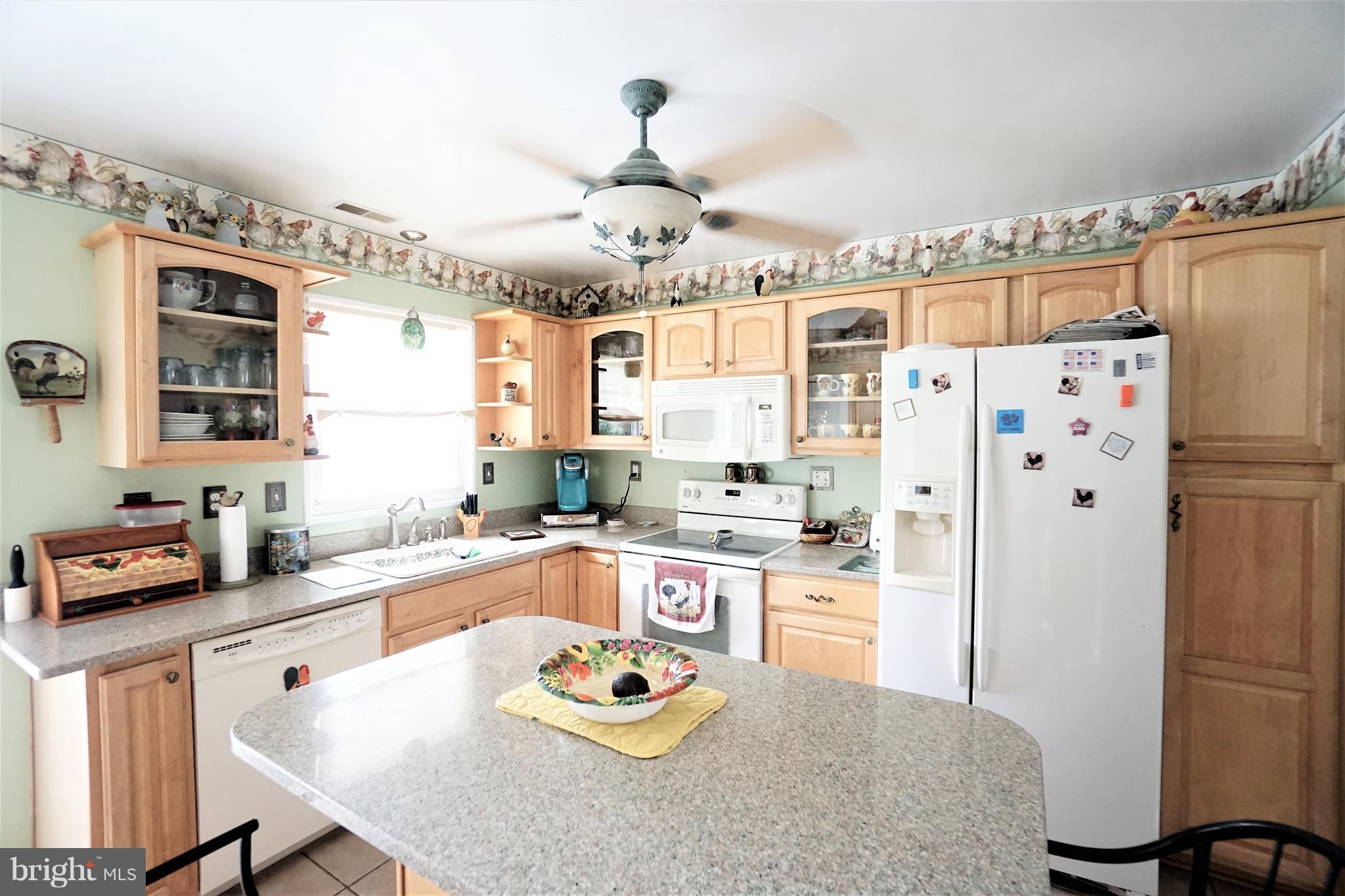 38 Peach Tree Drive Ranson, WV 25438 - Photo 8 of 30 a kitchen with a refrigerator a stove a sink and chairs