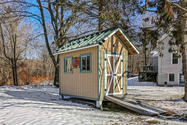 a view of a house with a yard covered with snow