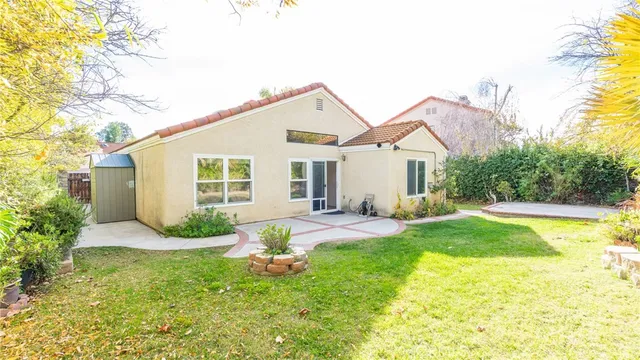 a front view of a house with yard and green space