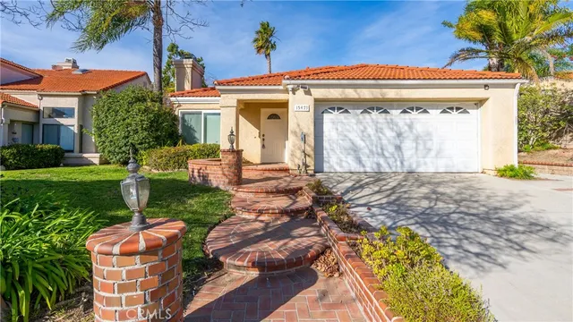 a front view of house with a garden