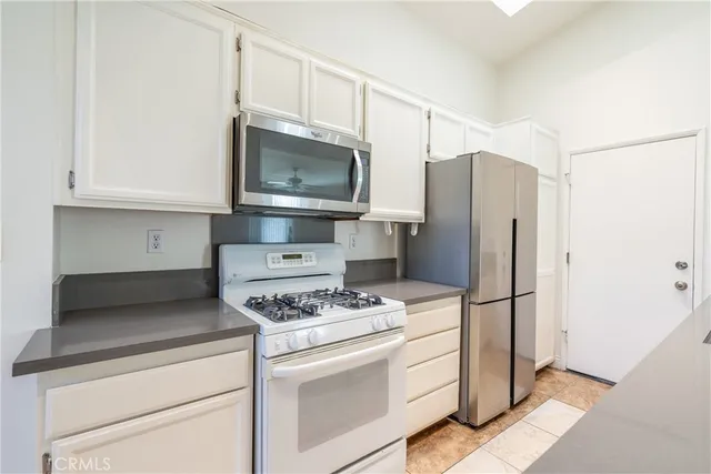a kitchen with stainless steel appliances a refrigerator stove and microwave