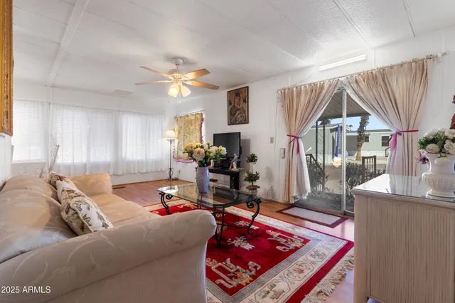 a living room with furniture a dining table and a chandelier