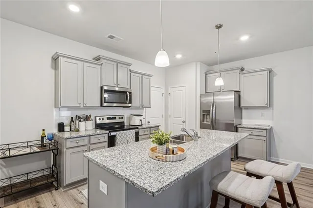 a kitchen with refrigerator and microwave