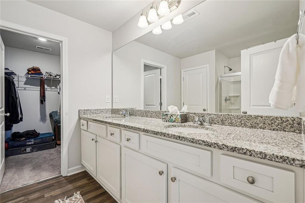 11692 Mendenhall Court Hampton, GA 30228 - Photo 14 of 25 a bathroom with a granite countertop sink and a mirror