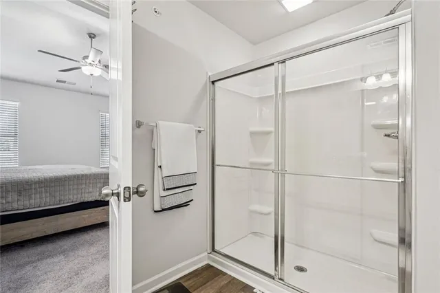a bathroom with a shower and a glass door