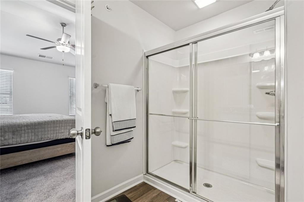 11692 Mendenhall Court Hampton, GA 30228 - Photo 16 of 25 a bathroom with a shower and a glass door