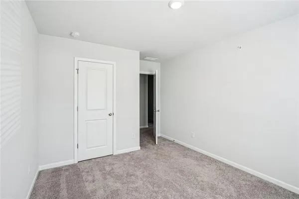 an empty room with closet area