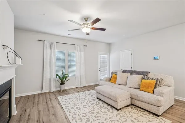 a living room with furniture and wooden floor