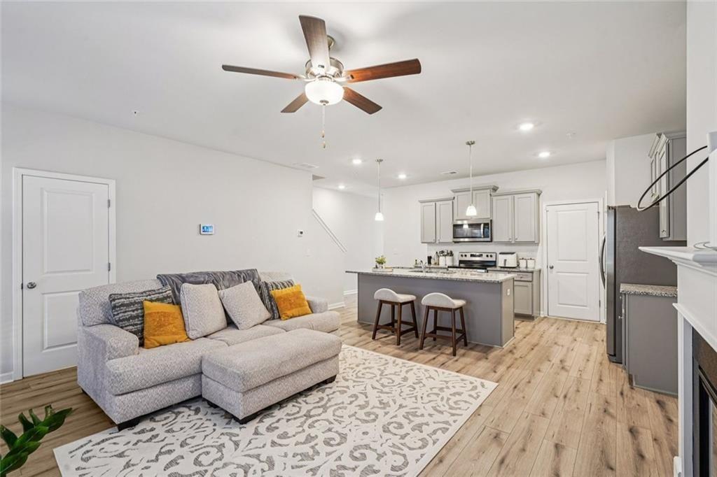 11692 Mendenhall Court Hampton, GA 30228 - Photo 6 of 25 a living room with furniture kitchen view and a wooden floor