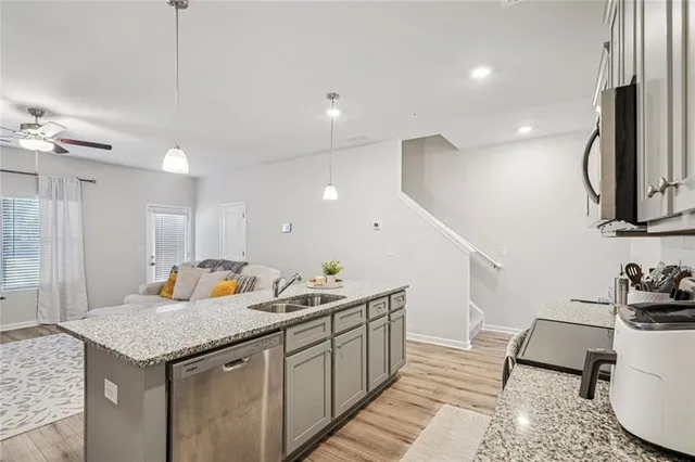 a kitchen with a sink a counter space and appliances