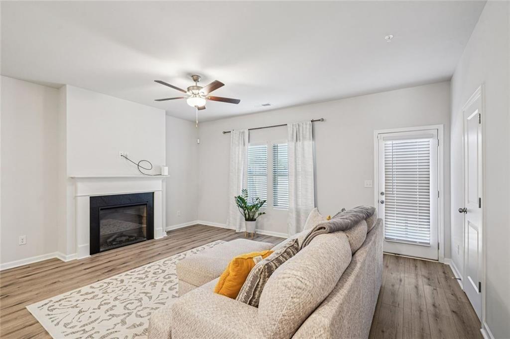 11692 Mendenhall Court Hampton, GA 30228 - Photo 9 of 25 a living room with furniture and a fireplace
