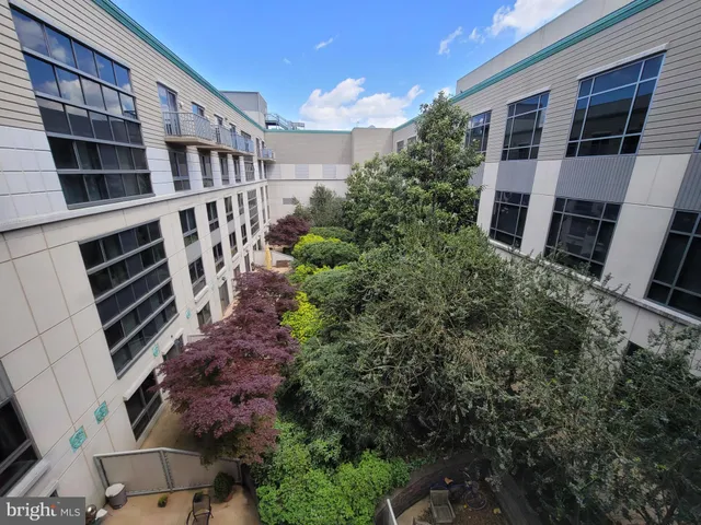 a view of building with large windows and a yard