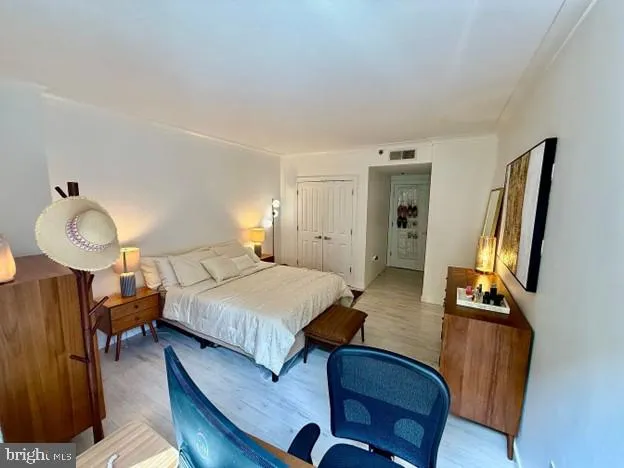 a bedroom with a bed window table and chair