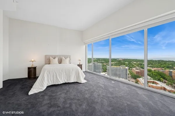 a bed sitting in a bedroom next to a large window