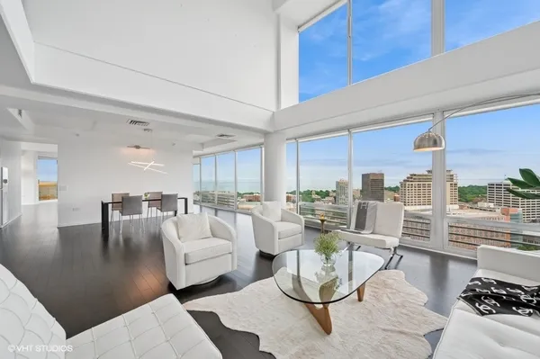 a living room with furniture and a view of kitchen