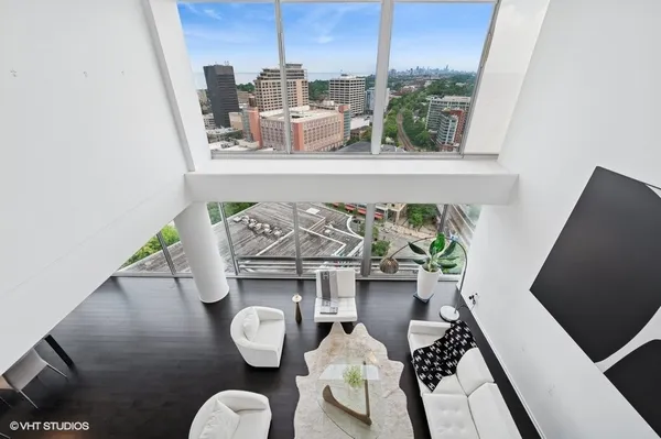 a living room with furniture and a floor to ceiling window