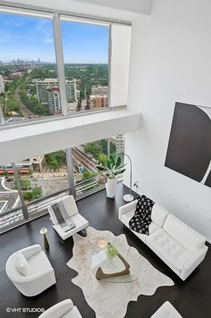 a living room with furniture and a floor to ceiling window