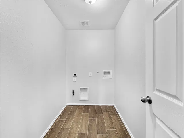 a view of a room with wooden floor