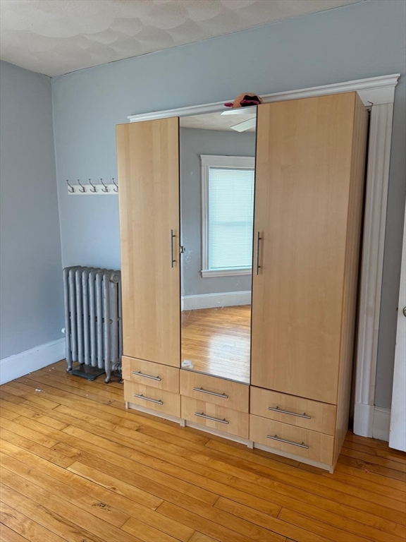 25 Seafoam Avenue, Unit 1 Winthrop, MA 02152 - Photo 12 of 17 an empty room with wooden floor and cabinet