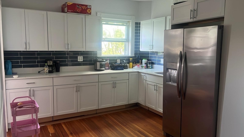 25 Seafoam Avenue, Unit 1 Winthrop, MA 02152 - Photo 4 of 17 a kitchen with a refrigerator sink and cabinets