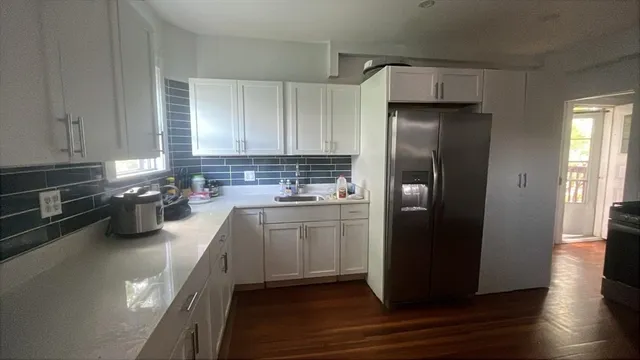 a kitchen with a refrigerator and a sink