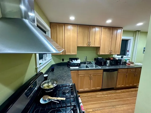 a kitchen with wooden cabinets and a sink
