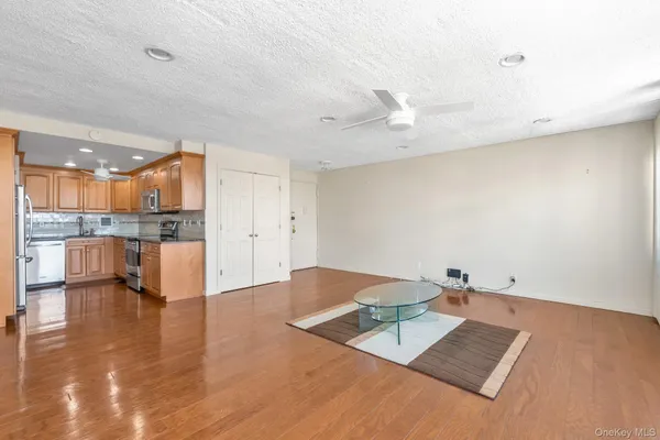a view of kitchen with kitchen island a sink stainless steel appliances and cabinets
