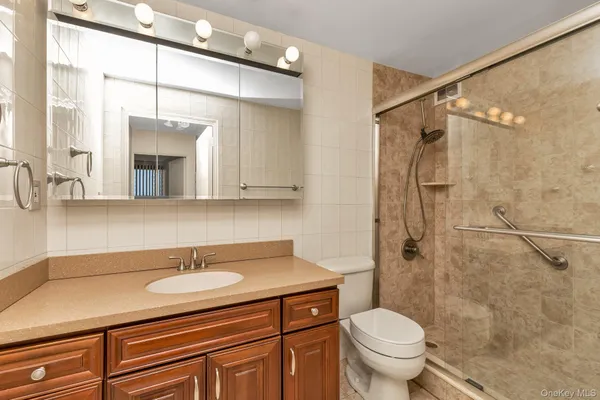 a bathroom with a sink toilet and shower