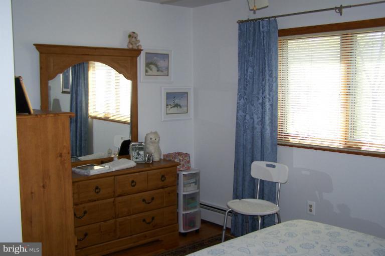 2005 Shore Drive Edgewater, MD 21037 - Photo 16 of 29 a bathroom with a toilet a sink a mirror and a window