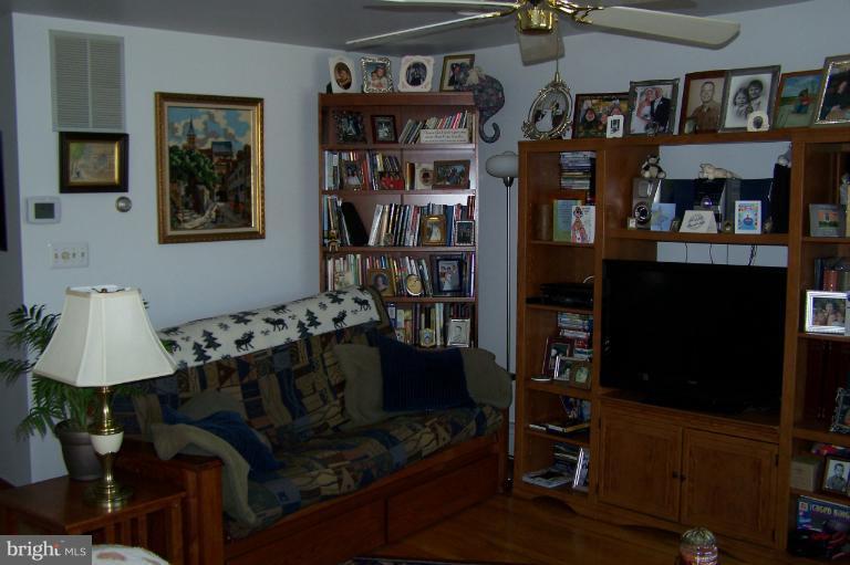 2005 Shore Drive Edgewater, MD 21037 - Photo 27 of 29 a living room with lots of furniture and a book shelf