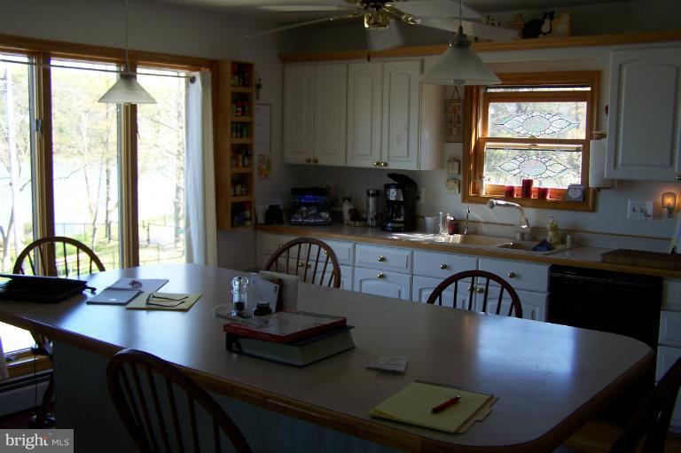 2005 Shore Drive Edgewater, MD 21037 - Photo 8 of 29 a kitchen with a table chairs stove and cabinets